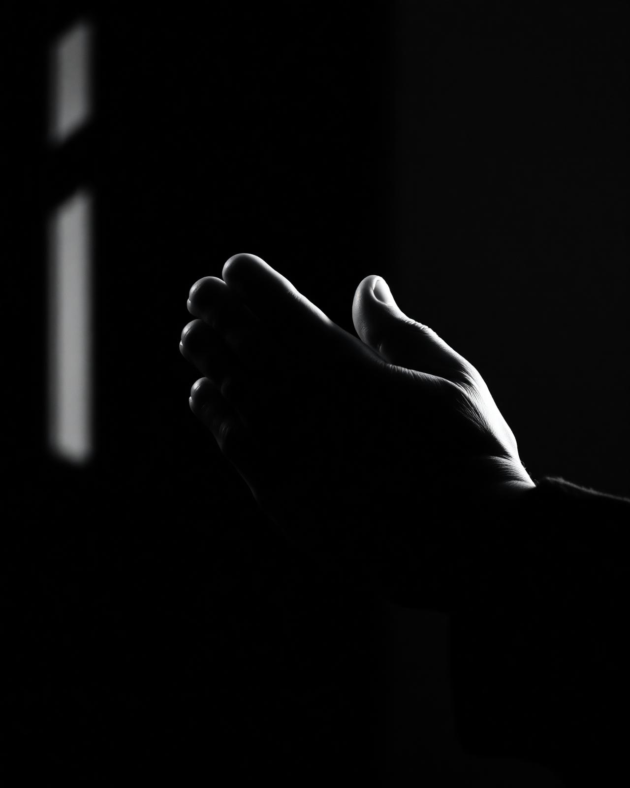Hands clasped in prayer